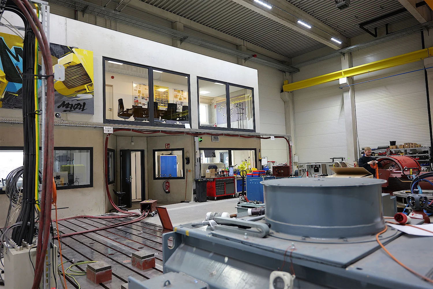 Soundproof customer lounge with direct view of motor test bays